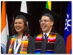 Whew! She can smile after all! Standing next to the other student speaker.